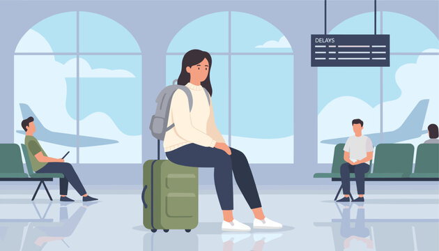 Tired and sad young female traveler sitting on suitcase at terminal waiting for delayed flight departure at airport.