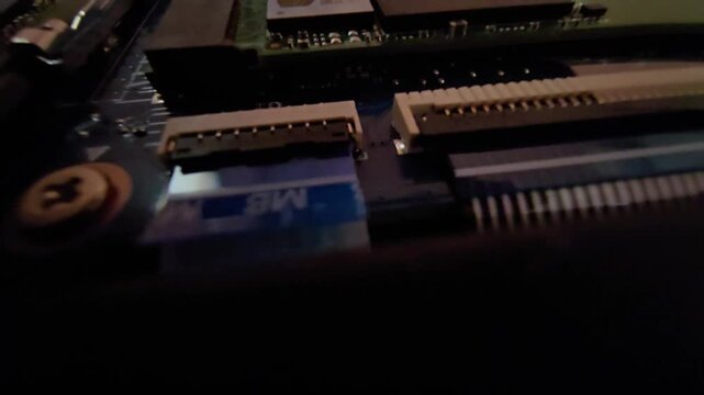 Macro close-up of computer motherboard electronic circuit board connectors and ribbon cable sockets.