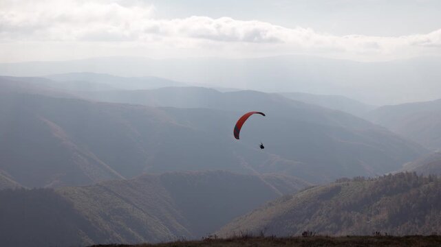 Paragliding active sport against giant mountains in highland