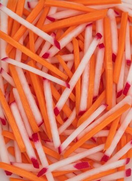 Julienne Fresh Carrots and Radishes Top View Background