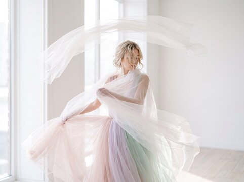 Ethereal Woman Dancing in Flowing Pastel Tulle Fabric in Bright Minimalist Studio