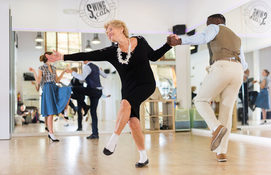 Senior womaSenior woman and man dancing swing in studion and man dancing swing in studio