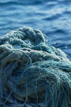 Blue rustic rope for the boat by the sea in marine close macro detail, nautical equipment background