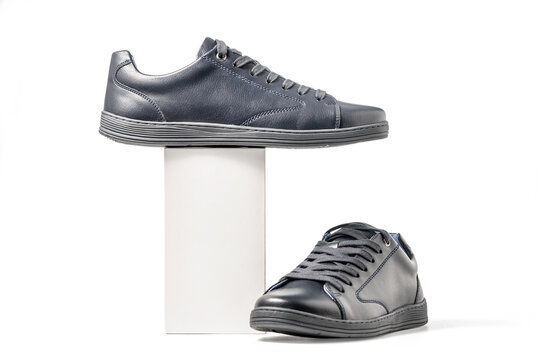 Black leather sneakers. Sport shoes isolated on white background, clipping path included