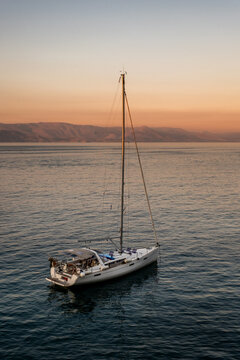 Sailboat in the sea in the evening sunlight, luxury summer adventure, active vacation in Mediterranean sea, Greece