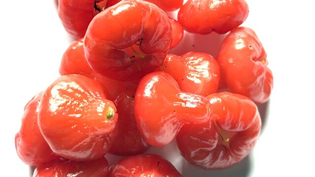 A heap of ripe red rose apples studio shot on white