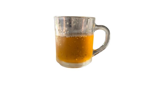 Clear glass mug filled with refreshing orange beverage on white background