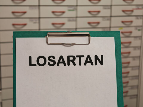 LOSARTAN angiotensin receptor blocker for hypertension and kidney protection displayed on a clipboard in a pharmacy
