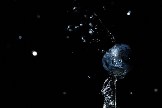 Fresh Blueberry Splash with Water Jet on Black Background