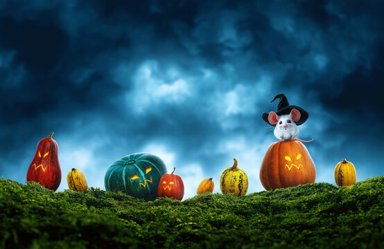 Cute mouse and evil colorful halloween pumpkins on grass