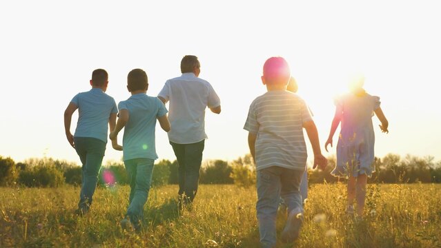 Child kid superhero, childhood dream flying, mother father run nature sunset, family running park summer, children playing outdoors at dusk, family time under a warm sky, kids running with parents