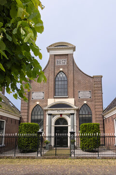 Historic canal bridge and 1857 brick church facade in IJlst, Friesland, Netherlands traditional Dutch architecture