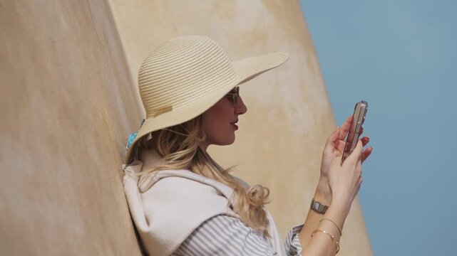 Woman Takes Phone Photos on Catania Rooftop Church, Sicily