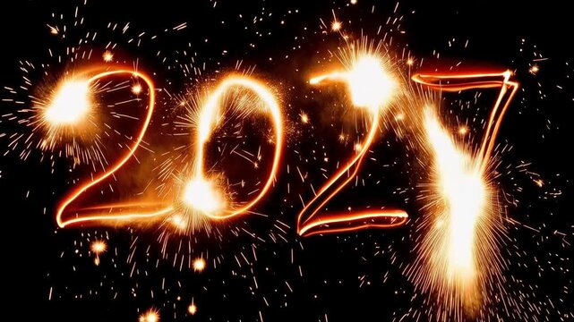 Glowing 2027 sparkler numbers on a black background, festive New Year celebration concept with bright fireworks and copy space