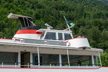 Modern passenger cruise ship with forested mountain background. © Anastazja