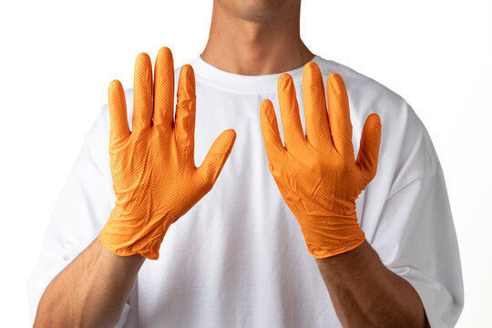 Person wearing orange protective safety gloves
