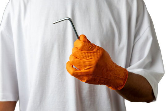 Worker hand holding hex wrench for repair