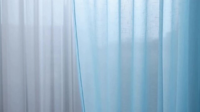 Close-up of light blue sheer curtains with subtle texture and soft lighting