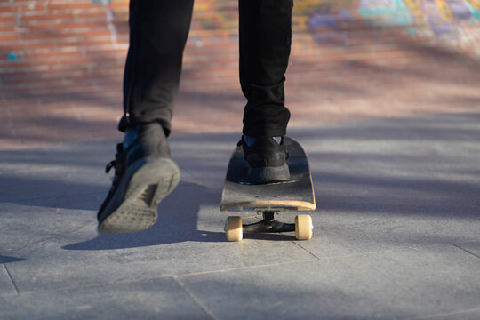 Legs of a young man riding a skate