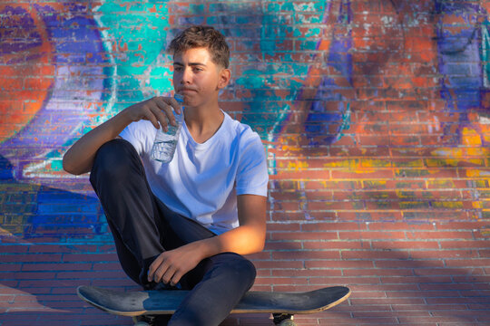 Young man sitting while drink water
