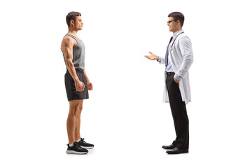 Fototapeta premium Doctor talking to a young fit man