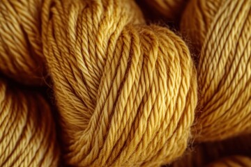 Fototapeta premium close-up of warm mustard yellow yarn skeins showing soft twisted fibers and cozy textured strands