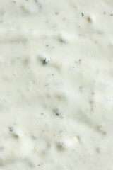 Obraz premium Close-up texture of creamy tartar sauce with herbs top view