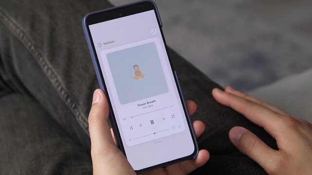 Hand navigating a calm audio player interface for meditation and relaxation. Highlights modern self-care routines, mindfulness practices, and emotional balance.