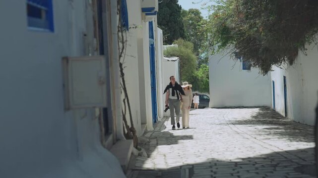Couple Walking Sidi Bou Said Cobbled Street, Tunisia