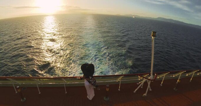 Woman on Cruiser Deck at Sunset: Golden Hour Aerial Ocean View