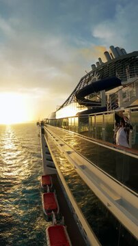 Sunset Serenity: Aerial of Woman on Luxury Cruise Ship Deck