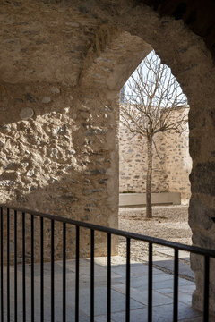 A close-up of the walls and an inner courtyard of an old, renovated house with exposed stone walls.