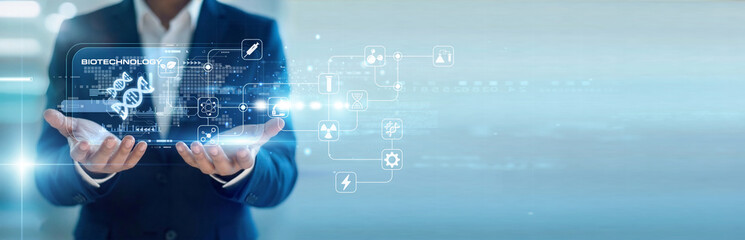 Obraz premium Medical researcher handhold virtual screen Biotechnology data while working on laptop for lab research. Genetic engineering and advanced molecular biology for healthcare breakthroughs.