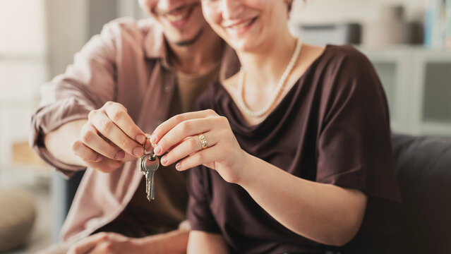 Happy couple holding the key to their new home