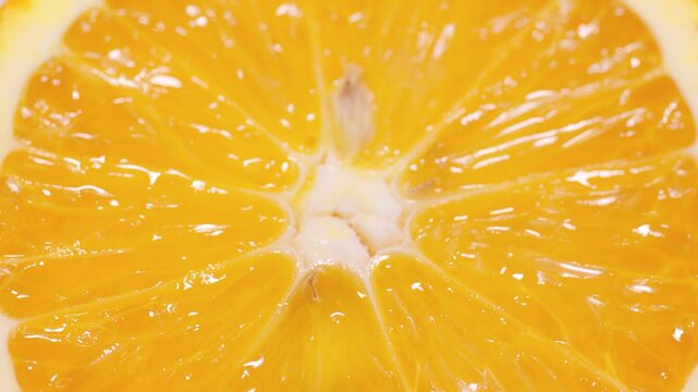 Marco shot an orange and turned it. Citrus. Close-up of citrus orange pulp. Orange slices. Fruit background. Smooth rotation in a circle