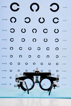 Professional ophthalmic trial frame with visual acuity chart, vertical