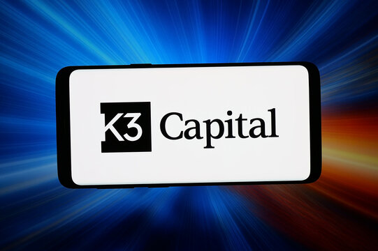 Stuttgart, Germany - 07-16-2026: In this photo illustration, the logo of digital assets consulting company K3 Capital is displayed on a smartphone in front of abstract background on computer screen.