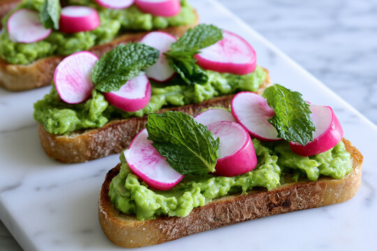 Spring toast with green pea puree, radishes, and fresh mint leaves