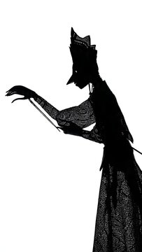 Silhouette of a person in a tall crown and detailed gown performs a precise hand gesture against a stark white background.