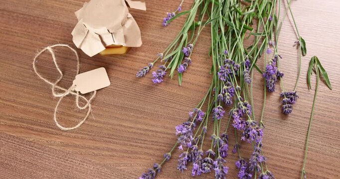 Handmade wedding favors craft ideas with lavender and sweet honey jar. Romantic rustic anniversary gift presentation layout on wooden table. Delicate marriage celebration banquet souvenirs mockup.