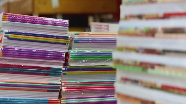 Colorful Stacks of Exercise Books and Notebooks on Store Shelves