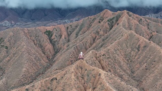 Scenic drone view of Sayakbai Statue overlooking Kyrgyzstan mountain landscape
