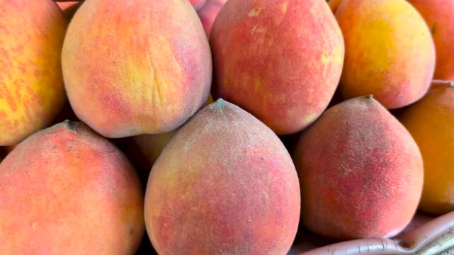 Fresh Peaches Stacked: A vibrant close-up showcases a delectable arrangement of ripe peaches, their fuzzy skins radiating a warm, inviting hue.