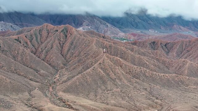 Majestic Sayakbai Karalaev Monument overlooking dramatic mountain scenery, Kyrgyzstan