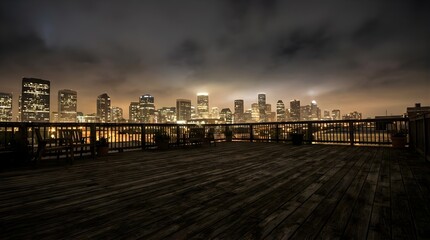 Fototapeta premium City skyline at night viewed from a wooden balcony.