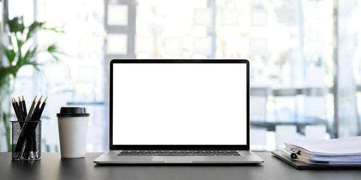 Laptop with blank screen on black table with cup and peper.