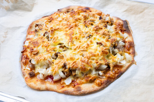 Shiitake mushroom, onion, and minced meat pizza on a baking sheet