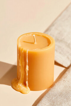 Yellow beeswax candle with impossible upward melting wax flows on a natural linen surface for wellness and self-care editorial campaigns