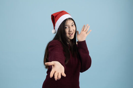 Surprised or scared young woman looking to the side with raised hands
