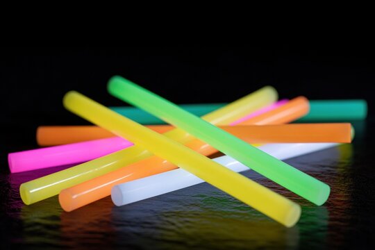 The Glow Sticks on Dark Surface Neon Colored Rods in a Casual Scatter